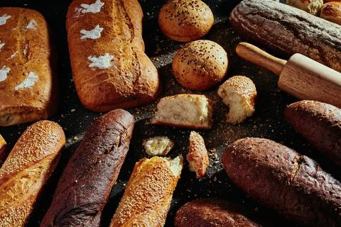 Pattern of bread. Bread assortment: baguettes, buns, loaves, dark and light Stock Photos