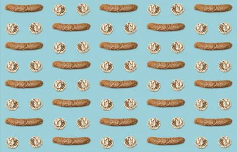Pattern of bread buns and dark baguette on blue background. Stock Photos