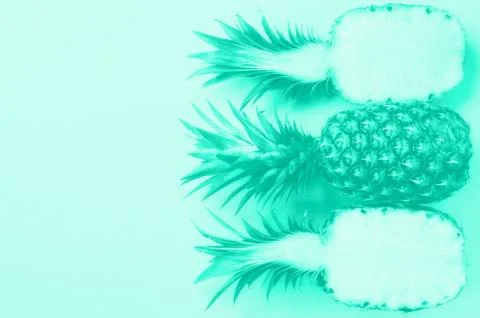 Pattern with bright pineapples on mint color background. Top View. Trendy green Stock Photos