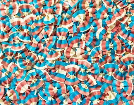 Pattern of bright tricolor pasta in the form of bows close-up Stock Photos