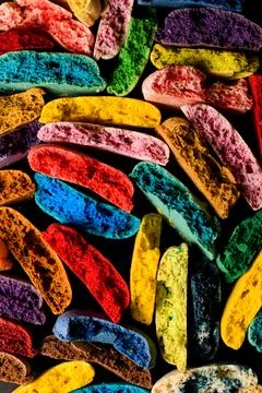 Pattern with broken and crushed multicolored macaron cookies halves laying 스톡 사진