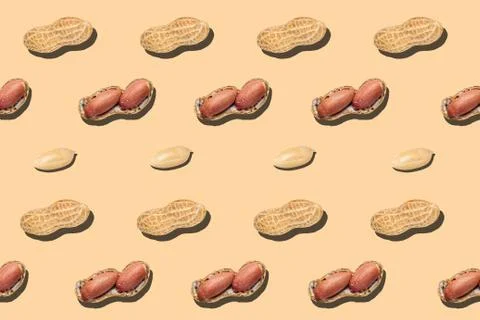 Pattern of broken peanuts on a orange background. Stock Photos