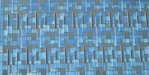 Pattern on a building's glass panes with different shades of blue and grey Fotos de archivo