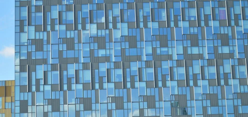 Pattern on a building's glass panes with different shades of blue and grey Stock Photos