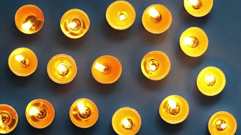 Pattern of burning yellow candles on dark blue, top view, close-up, burning.. Stock Footage 232705760