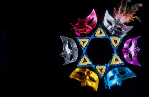 Pattern of carnival masks and triangle cookies on black background. Jewish Pu Stock Photos