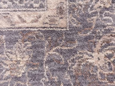 Pattern on the carpet in gray and beige tones Stock Photos