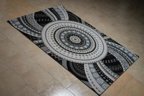 Pattern carpet lying on floor Stock Photos