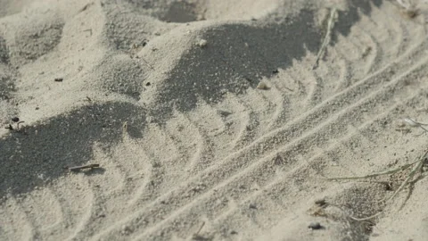 Pattern of cars tire imprinted on white sand 4K video Stock Footage 196204630