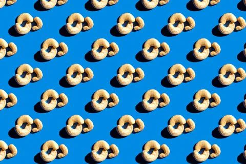 Pattern of cashew. Fashionable sunny porridge pattern on a bright blue backgr Stock Photos
