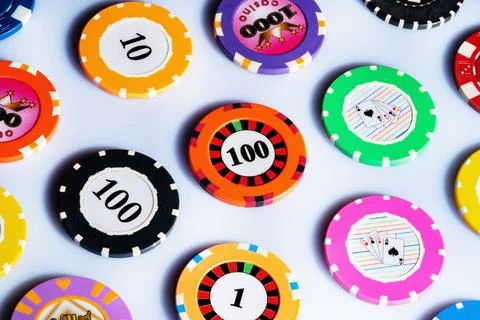 Pattern from casino chips on white isolated background. Casino chips denominated Stock Photos