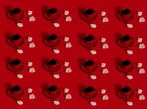 Pattern of ceramic coffee cup with coffee in a red saucer, next to a crumpled Stock Photos