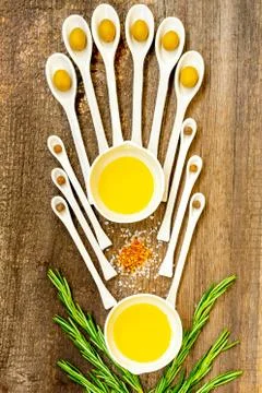 Pattern of ceramic spoons with olives and spices. Stock Photos