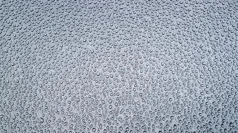 Pattern of chaotic drops of rain water passed day before on metal in morning. Stock-Fotos