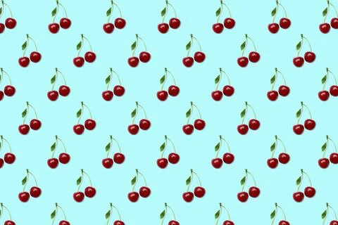Pattern of cherries on pale light blue background Fotos de archivo
