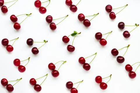 Pattern of cherries with petioles lined in rows on white background. Stock Photos