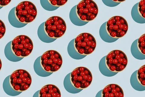 Pattern of cherry tomatoes in bamboo bowl on pastel blue, healthy eating concept Stock Photos