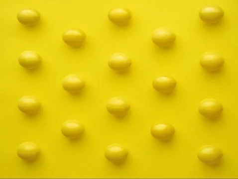 Pattern Of Chicken Eggs In Line Against Yellow Background Stock Photos