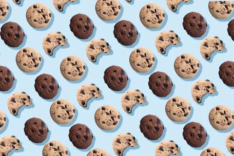 A pattern of chocolate chip cookies on a blue background. Stock Photos