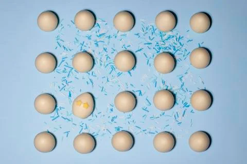 A pattern of chocolate eggs with one egg with star-eyes tilted slideways Stock Photos