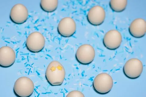 A pattern of chocolate eggs with one special egg and sweet powder Stock Photos