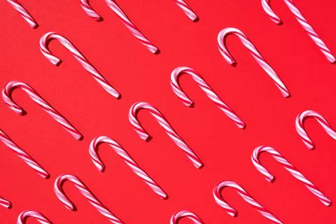 Pattern of Christmas candy cane on red background. Top view. Flat lay. Creative Stock Photos