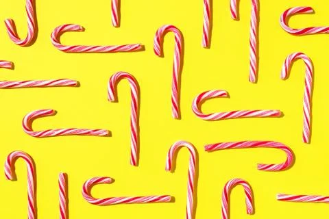Pattern of Christmas candy cane on yellow background. Top view. Flat lay Foto stock