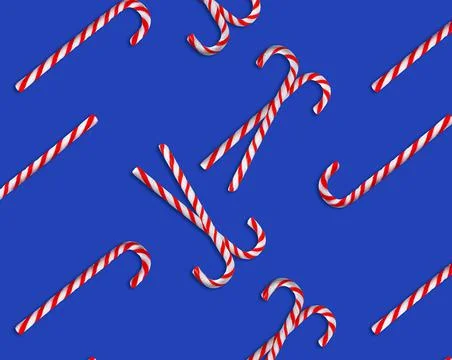 Pattern of Christmas candy canes on blue background, top view Stock Photos