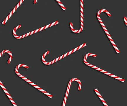 Pattern of Christmas candy canes on dark grey background, top view Stock Photos