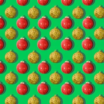 Pattern of Christmas tree balls red and gold on a green background Stock Photos