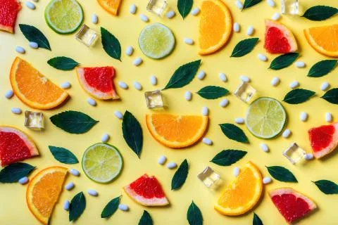 Pattern of citrus lemon, lime, orange and grapefruit slices and mint herbs on Stock Photos
