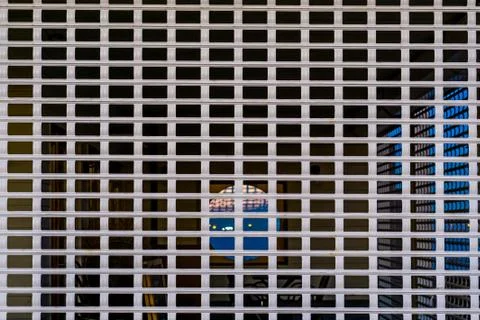 Pattern of a closed shutter with holes you can see through, security system f Foto stock