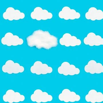 Pattern with clouds on a blue background. White clouds cut out of paper and Stock Photos