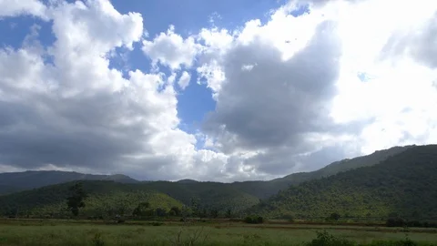 Pattern of clouds on blue sky over green mountain range in rural India 動画素材 111304066