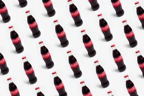 Pattern of coca cola bottles isolated on white background. Chisinau, Moldov.. Stock Photos