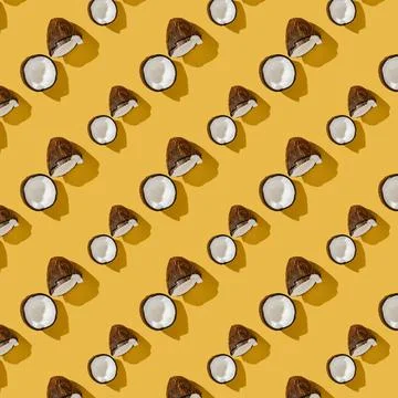 A pattern of coconuts on a bright yellow background. Foto stock