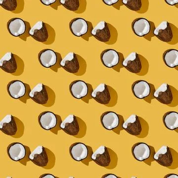 A pattern of coconuts on a bright yellow background. Foto stock