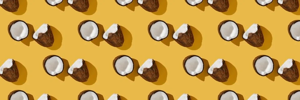 A pattern of coconuts on a bright yellow background. Stock Photos