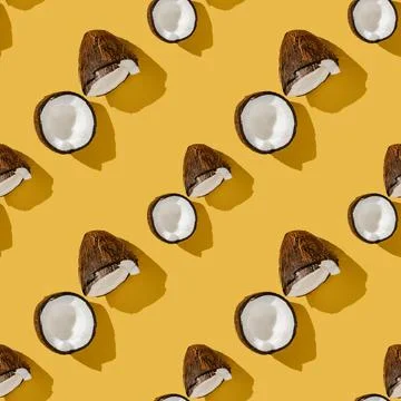 A pattern of coconuts on a bright yellow background. Foto stock