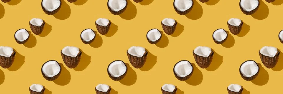 A pattern of coconuts on a bright yellow background. Foto stock
