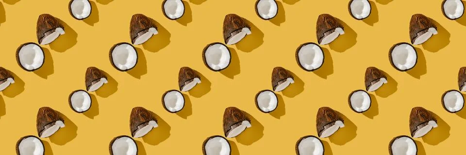A pattern of coconuts on a bright yellow background. Stock Photos