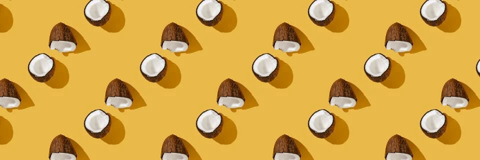 A pattern of coconuts on a bright yellow background. Foto stock
