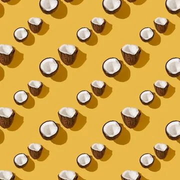 A pattern of coconuts on a bright yellow background. Foto stock