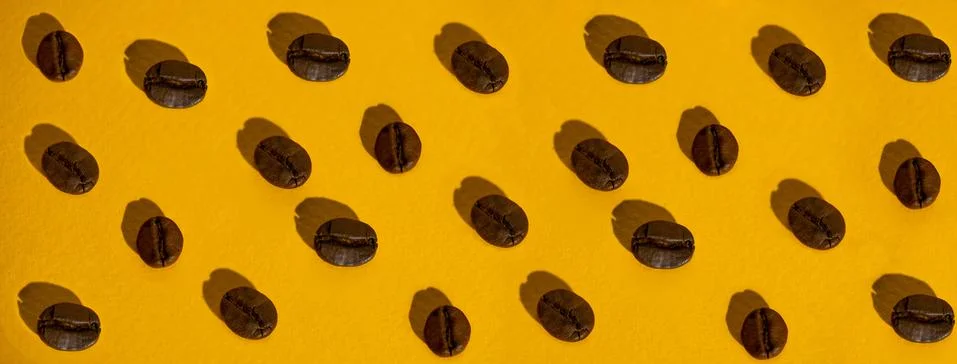 The pattern of coffee beans on colored background Stock Photos