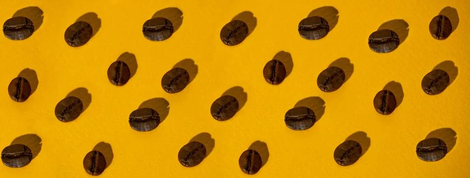 The pattern of coffee beans on colored background Stock Photos