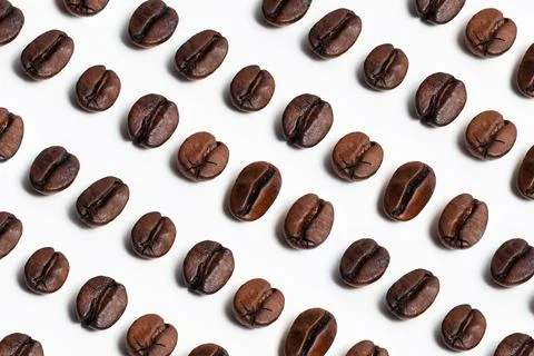 Pattern of coffee beans isolated on white background. Stock Photos
