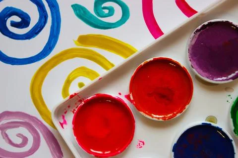 Pattern of colored painted spirals, background from watercolor paints and gou Stock Photos