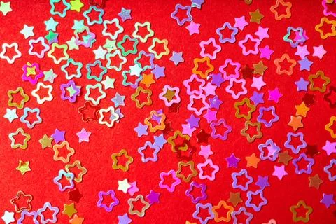 Pattern of colored stars on a red background. New year background concept Stock Photos