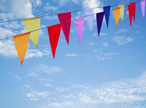 Pattern of the colorful flags hanging with blue sky as a background 스톡 사진