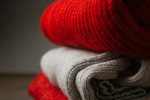 Pattern of colorful knitted sweaters closeup. Handmade merino wool product... Stock Photos